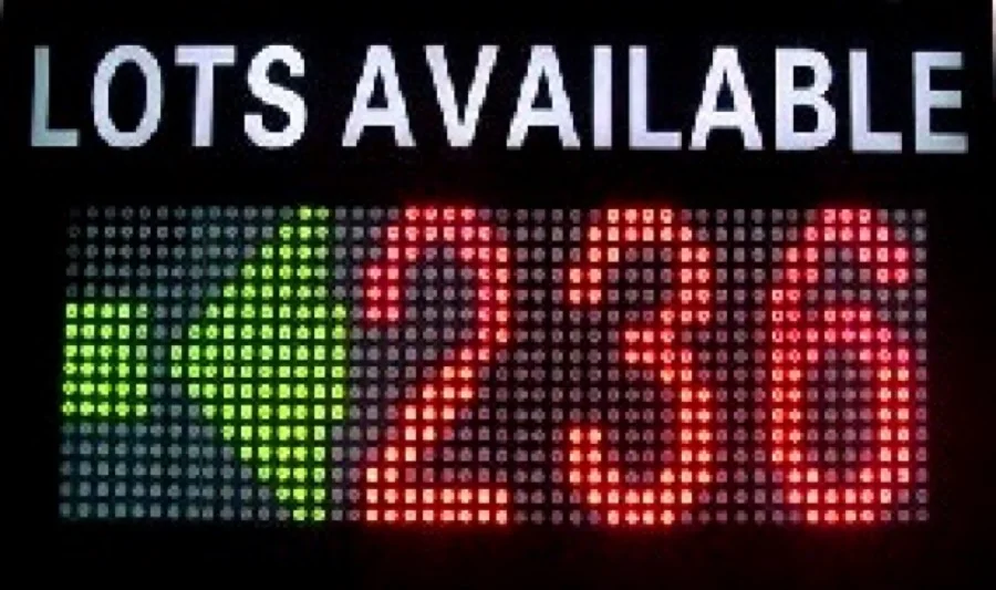 LED parking space availability display sign showing open space counts by level