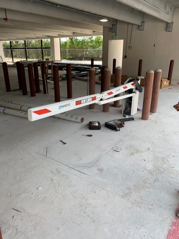Parking barrier gate arm and operator housing during installation in a parking structure