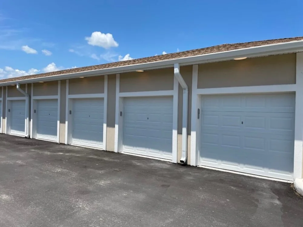 Newly installed residential garage doors across a multi-unit residential building